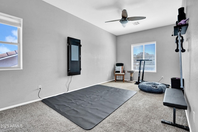 exercise area featuring carpet flooring, baseboards, visible vents, and ceiling fan