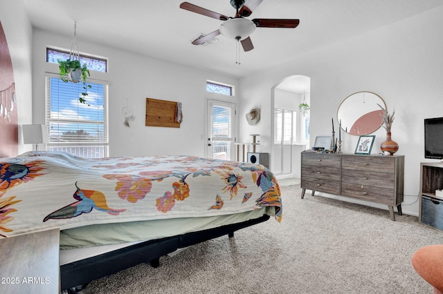 bedroom featuring arched walkways, carpet flooring, visible vents, and ceiling fan