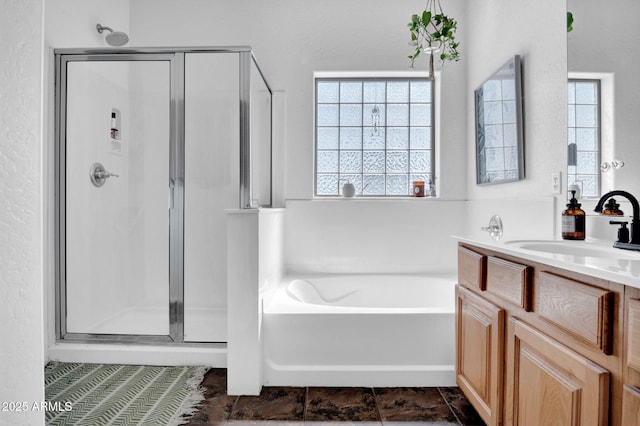 full bath featuring vanity, a bath, and a stall shower