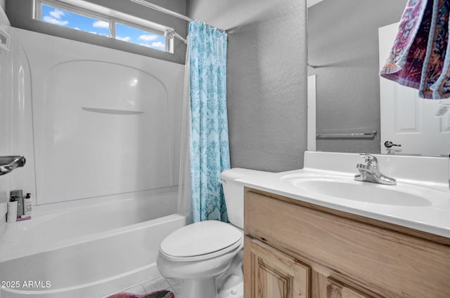 full bathroom with vanity, toilet, shower / bath combo with shower curtain, and a textured wall