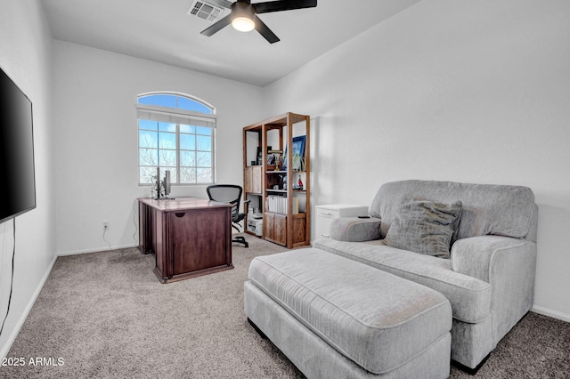 office area with visible vents, light colored carpet, a ceiling fan, and baseboards