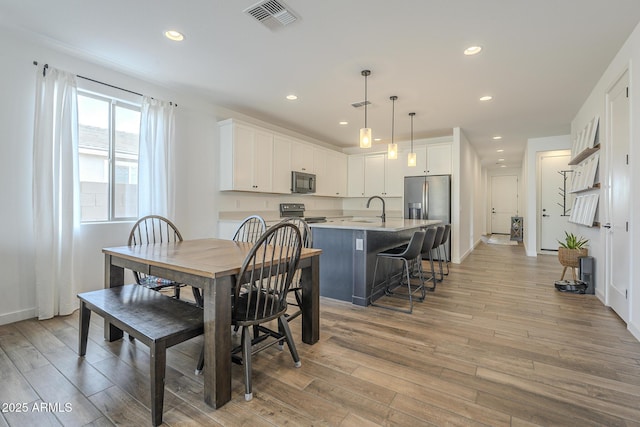 dining room featuring recessed lighting, visible vents, and light wood finished floors