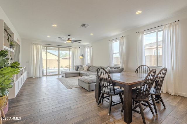 dining area with wood finished floors, visible vents, and recessed lighting