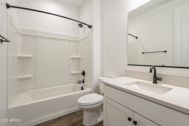 full bath featuring toilet, shower / bath combination, wood finished floors, and vanity