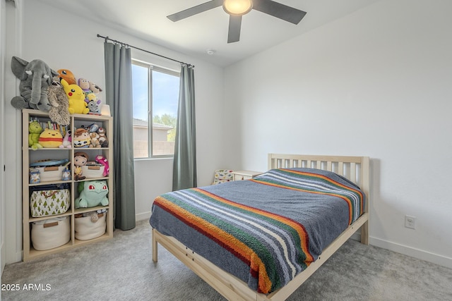 carpeted bedroom with ceiling fan and baseboards