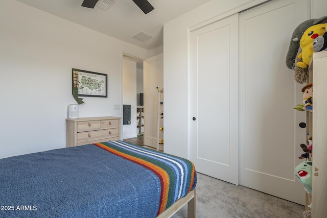 bedroom with carpet, a closet, visible vents, and ceiling fan