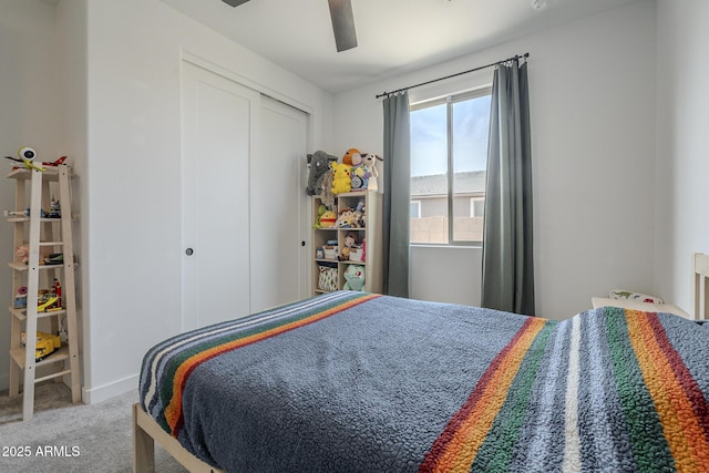 bedroom featuring ceiling fan, a closet, carpet flooring, and baseboards