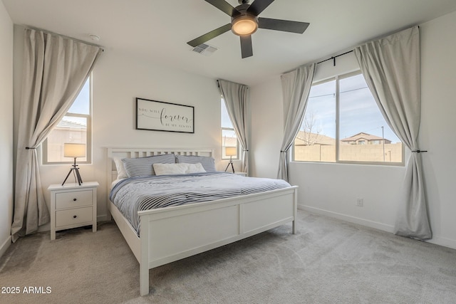 carpeted bedroom with ceiling fan, visible vents, and baseboards