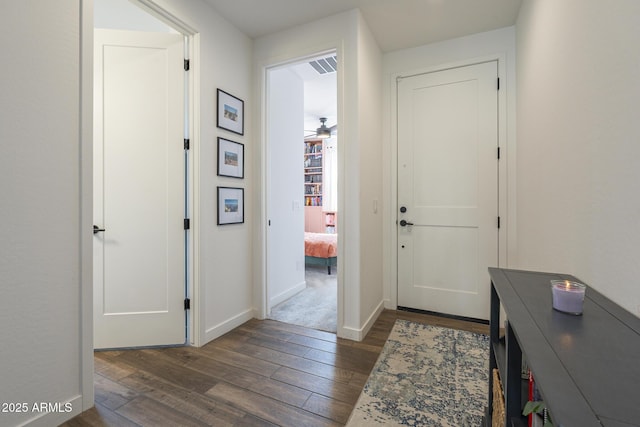 entryway with dark wood-style floors and baseboards