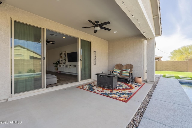 view of patio featuring ceiling fan, visible vents, and fence