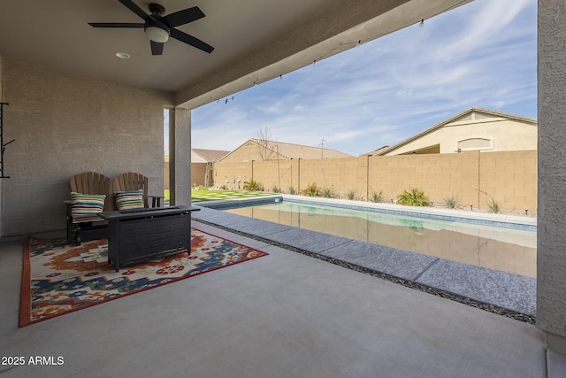 view of patio / terrace featuring a ceiling fan, a fenced in pool, and a fenced backyard