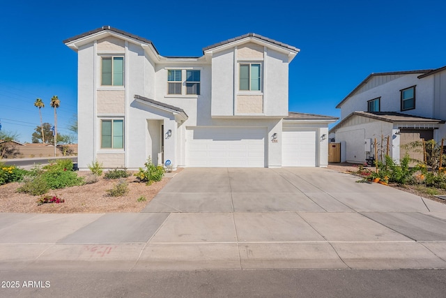 view of front facade with a garage, driveway, and stucco siding