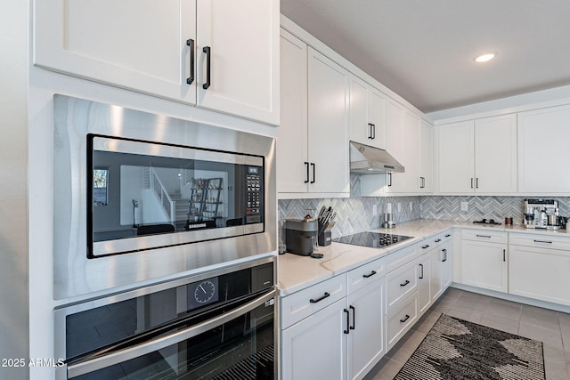 kitchen featuring white cabinets, under cabinet range hood, and stainless steel appliances