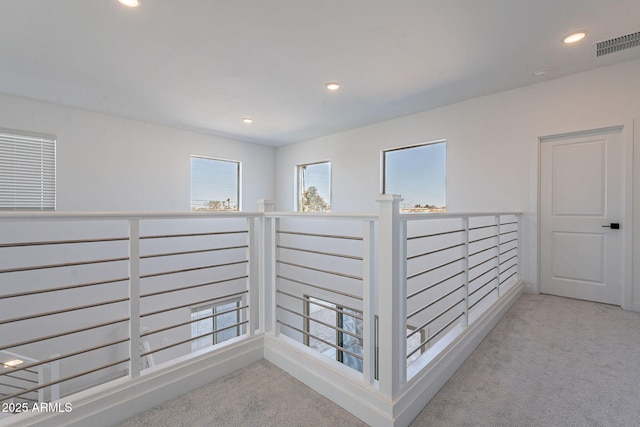 hallway with recessed lighting, visible vents, and light colored carpet