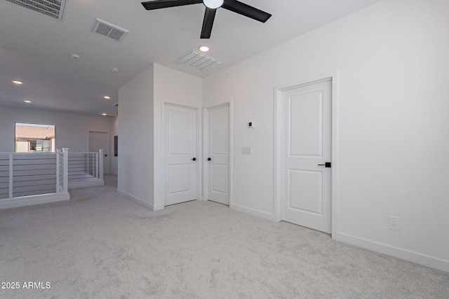 empty room featuring light carpet, baseboards, and visible vents