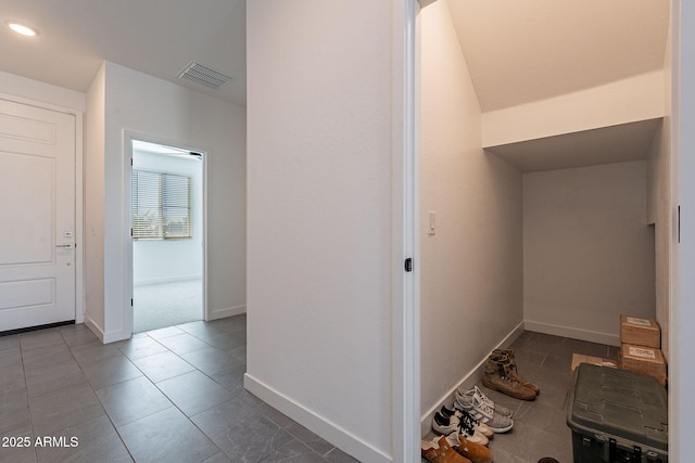 hallway featuring tile patterned floors, baseboards, visible vents, and recessed lighting