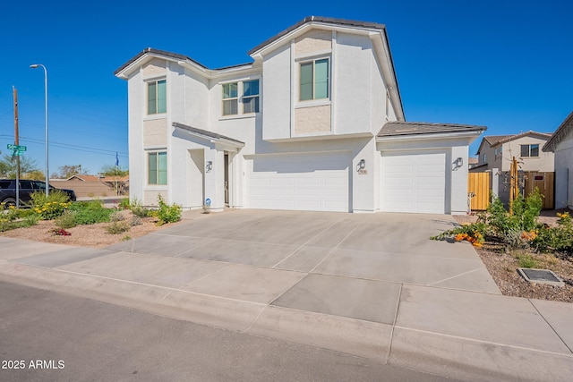 view of front of property featuring a residential view, concrete driveway, an attached garage, and stucco siding