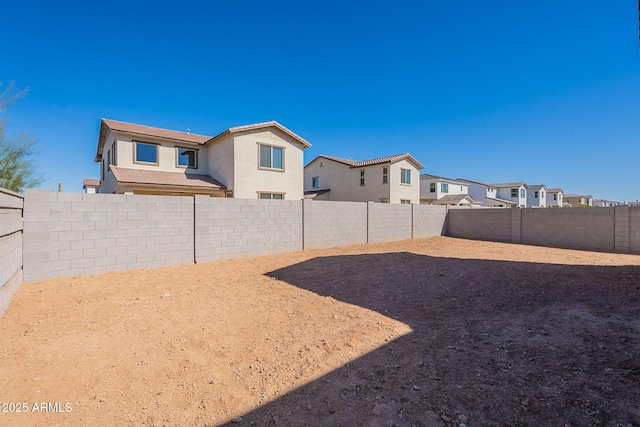 view of yard featuring a residential view and a fenced backyard