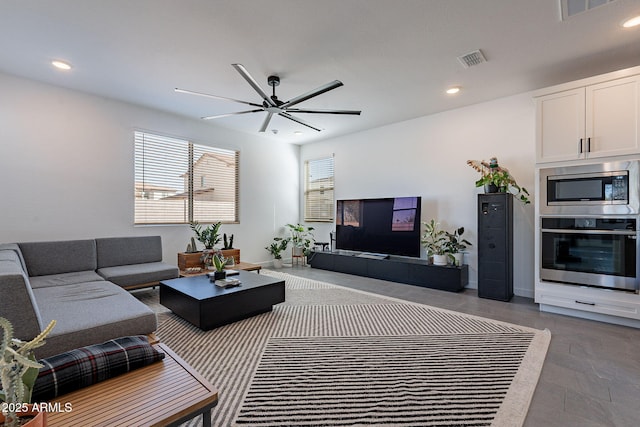 living room with visible vents, a ceiling fan, and recessed lighting