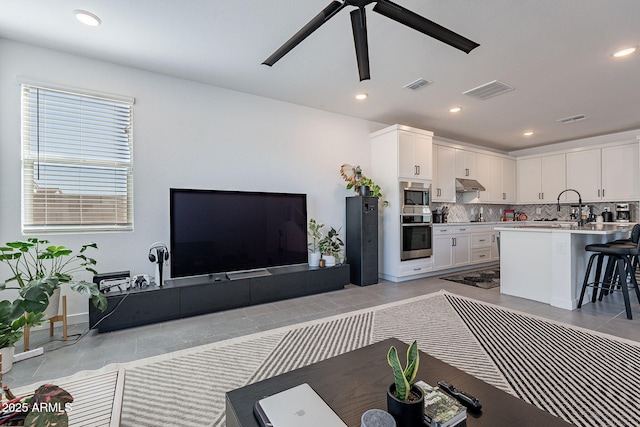 living room featuring recessed lighting, visible vents, ceiling fan, and light tile patterned flooring