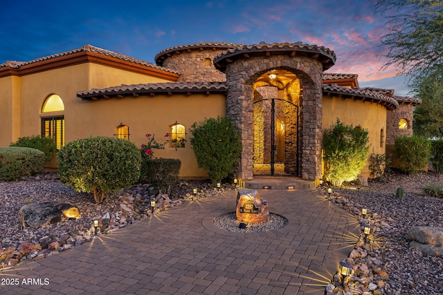 mediterranean / spanish-style house featuring a patio area