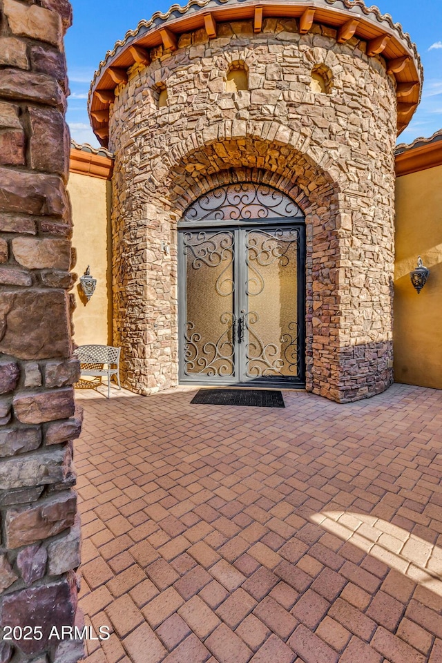 view of exterior entry featuring french doors