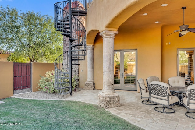 view of patio featuring ceiling fan and french doors