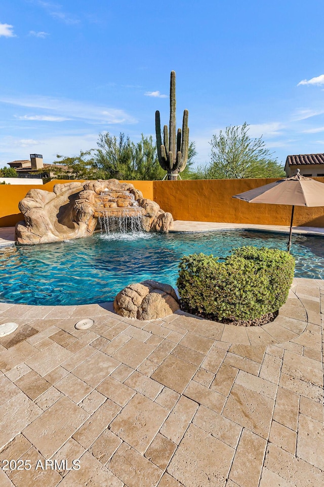 view of swimming pool with pool water feature