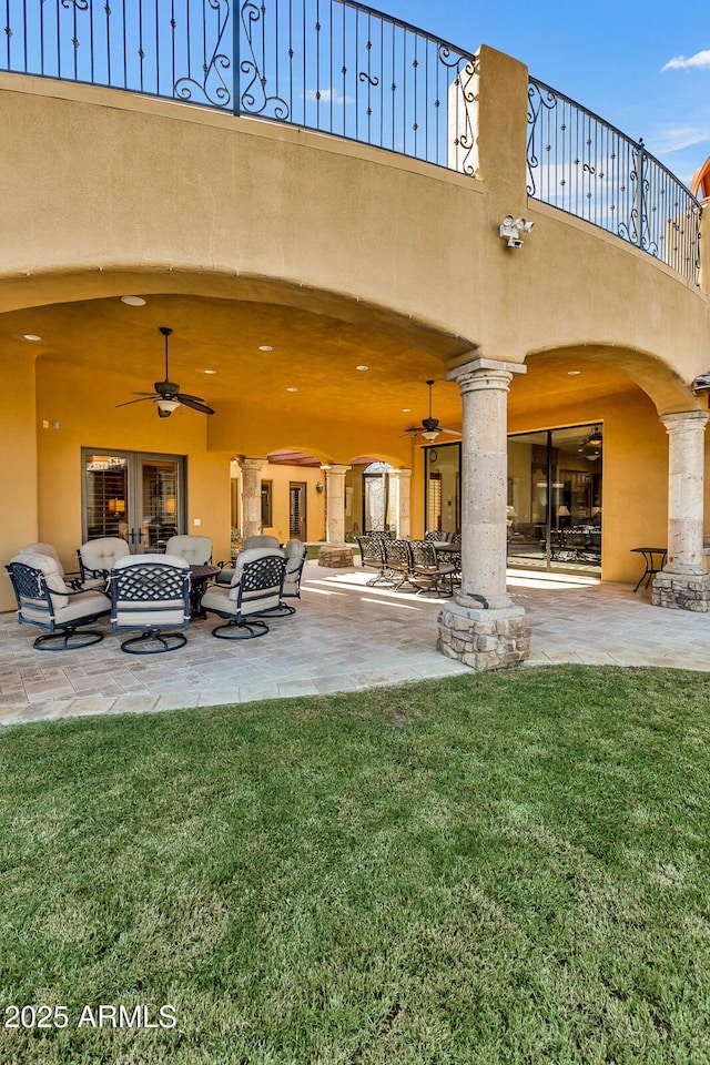 view of patio with outdoor lounge area, ceiling fan, and a balcony