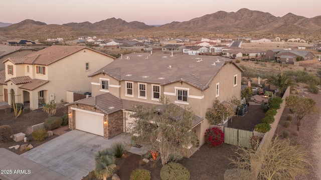 view of front of home with a mountain view, a residential view, and stucco siding