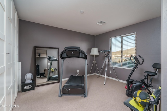 workout room with carpet flooring, visible vents, and baseboards