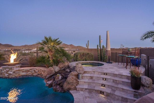 view of swimming pool featuring a fenced in pool, a patio area, a mountain view, fence, and an in ground hot tub