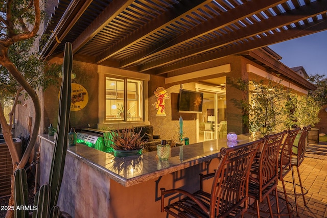 view of patio featuring outdoor dry bar and a pergola