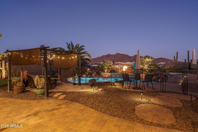 view of pool featuring a mountain view, a patio, and a fenced in pool