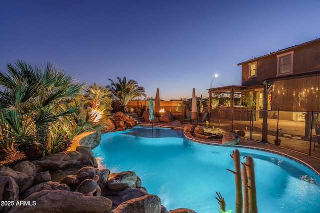 pool at dusk with a patio, a fenced backyard, and a fenced in pool