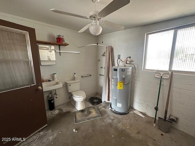 513 S Cardinal Dr, Apache Junction, AZ 85120 - full bath featuring water heater, concrete floors, tiled shower, ceiling fan, and toilet