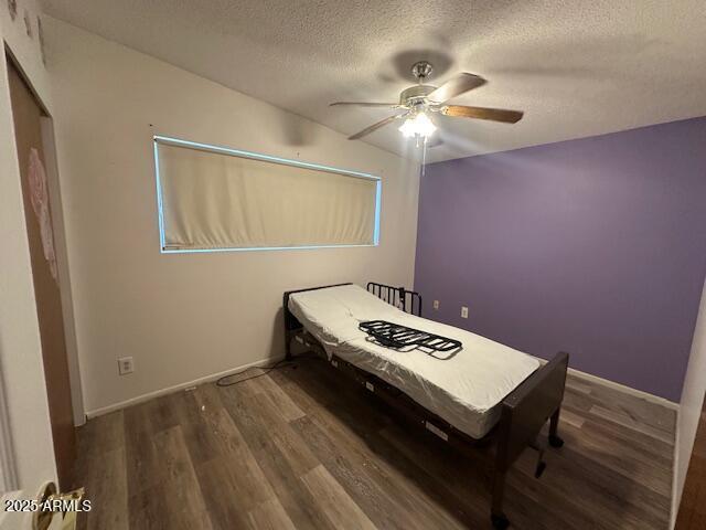 513 S Cardinal Dr, Apache Junction, AZ 85120 - bedroom featuring wood finished floors, a textured ceiling, ceiling fan, and baseboards