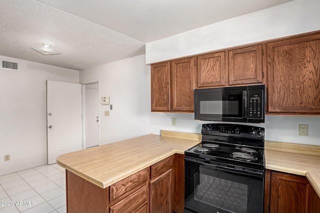 7849 E Golf Ave, Mesa, AZ 85209 - kitchen featuring black appliances, a peninsula, light countertops, brown cabinets, and a textured ceiling