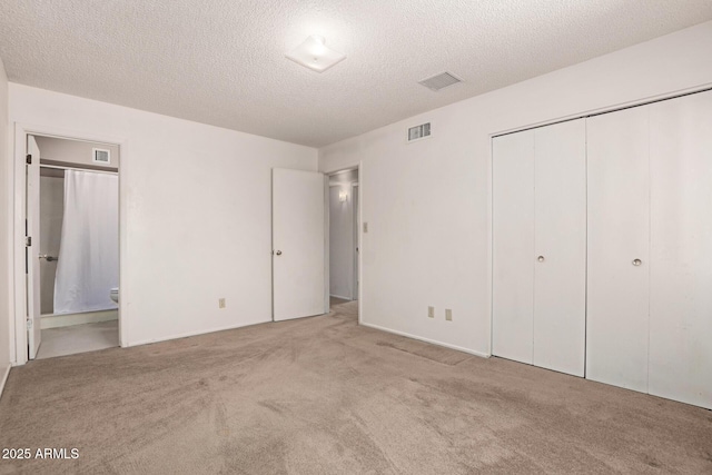 7849 E Golf Ave, Mesa, AZ 85209 - unfurnished bedroom featuring carpet floors, a textured ceiling, a closet, and ensuite bathroom