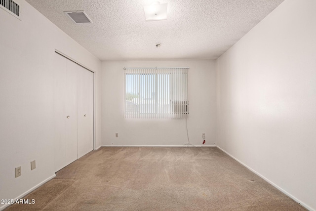7849 E Golf Ave, Mesa, AZ 85209 - unfurnished bedroom featuring carpet, a textured ceiling, baseboards, and a closet