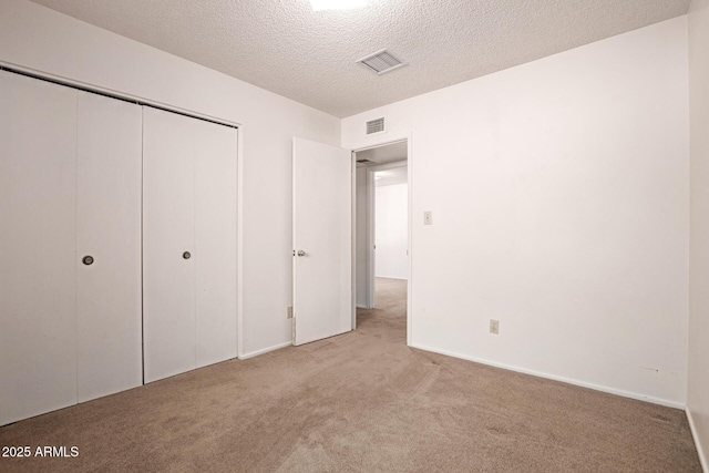 7849 E Golf Ave, Mesa, AZ 85209 - unfurnished bedroom with carpet, a textured ceiling, and a closet