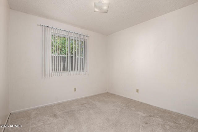 7849 E Golf Ave, Mesa, AZ 85209 - carpeted spare room with a textured ceiling and baseboards