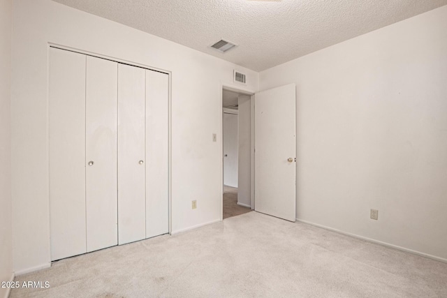 7849 E Golf Ave, Mesa, AZ 85209 - unfurnished bedroom with a textured ceiling, carpet floors, a closet, and baseboards