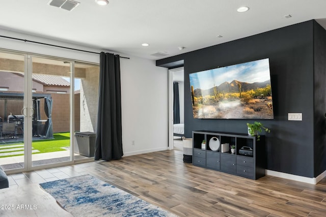 living area with wood finished floors, recessed lighting, baseboards, and visible vents