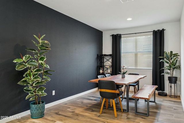 dining room with baseboards, visible vents, wood finished floors, and recessed lighting