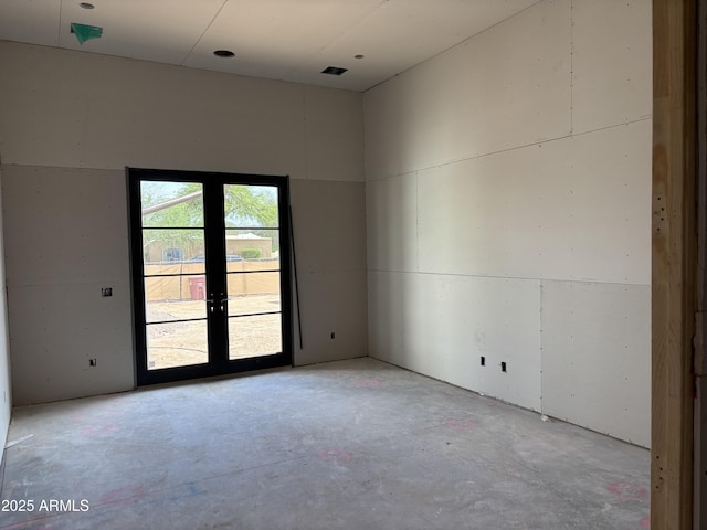 6426 E Turquoise Ave, Paradise Valley, AZ 85253 - spare room featuring unfinished concrete flooring and french doors