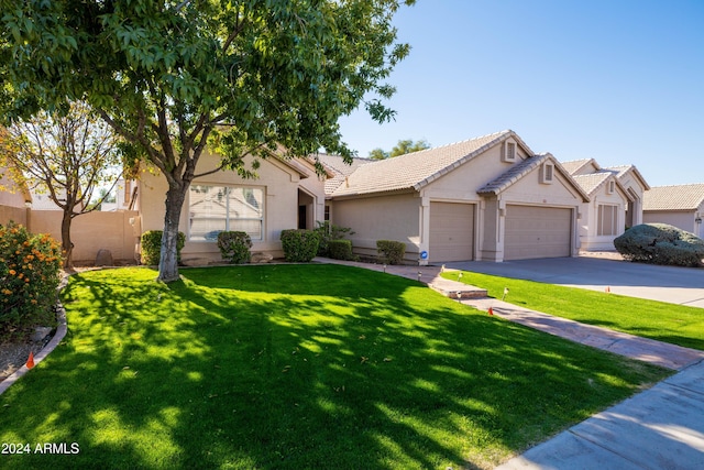 ranch-style home featuring a garage and a front lawn