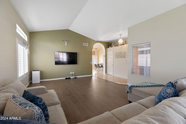 living room with hardwood / wood-style floors and lofted ceiling