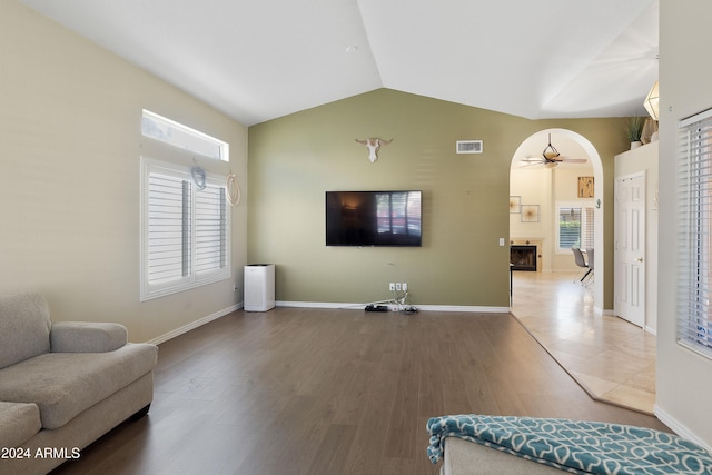 living room with hardwood / wood-style flooring, vaulted ceiling, and ceiling fan