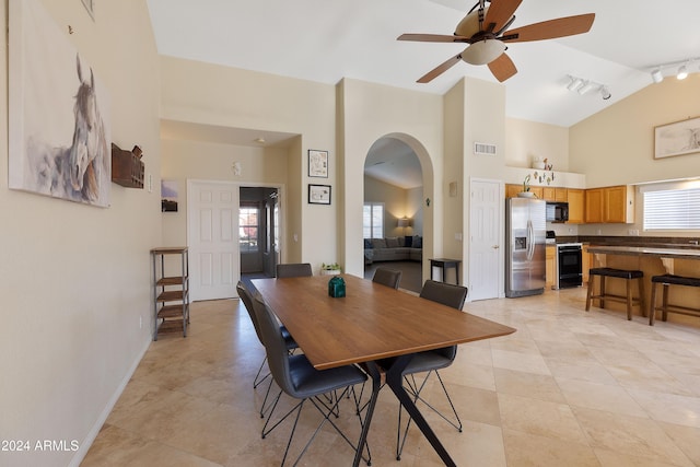 dining space featuring ceiling fan, light tile patterned floors, high vaulted ceiling, and track lighting